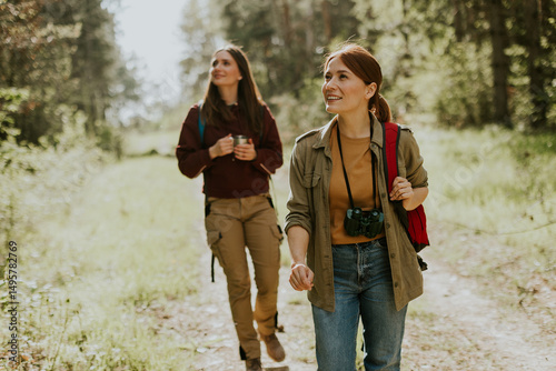 Two friends explore a lush ...