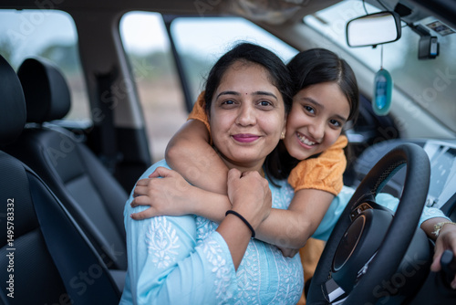 Indian young mother and daughter travelling by car