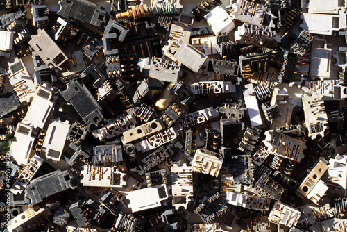 Bilde på lerret Mobile phone charging connectors are removed from old phones and are collected for recycling and extraction of precious metals from electronic waste