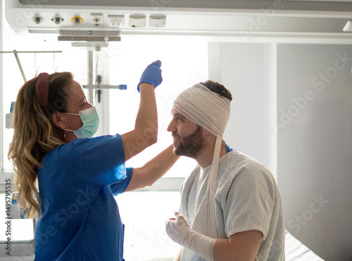 Konstfotografi Nurse changing bandages of patient recovering in hospital bed