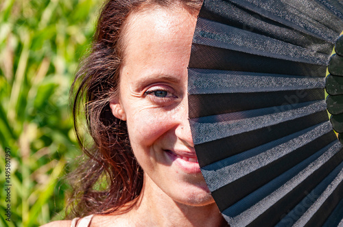 Secret gaze of dancer. Eyes of mystery feminine strength. Mysterious eyes behind traditional fans. Flamenco dancer. Woman eyes red black fan. Cultural folk elegance hidden face. Geisha girl smile