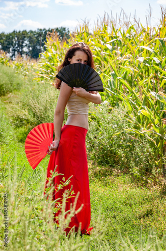 Folk culture. Traditional dance flamenco. Artistic lifestyle. Global tourism. Feminine freedom. Folkloric girl travel. Flamenco dancer. Woman in red skirt with fans dance in field. Artistic lifestyle