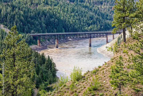 Obraz na plátně A railroad bridge crosses the Fraser River in the dense forest near Lytton, Brit
