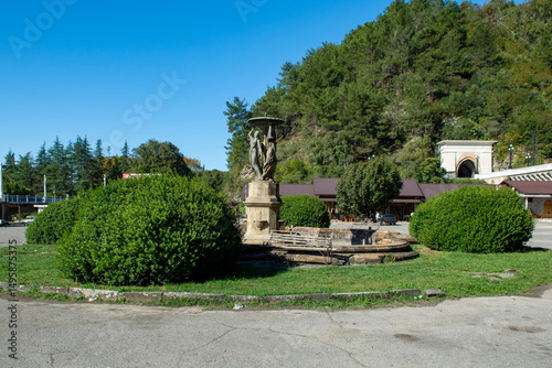 An abandoned fountain on a square in the resort town of Gagra, Abkhazia. An abandoned beautiful sculpture in a resort town. A sunny warm day