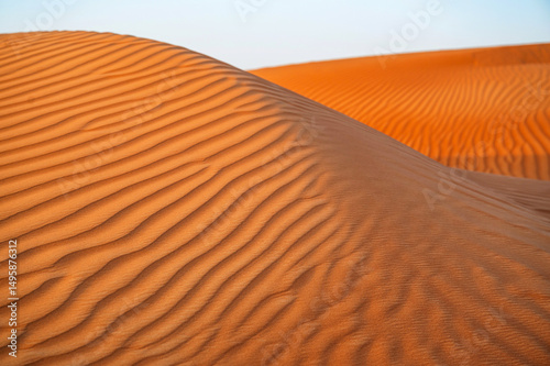 Fototapeta Naklejka Na Ścianę i Meble -  2 orange dunes with natural rippled surface, Ras Al Khaimah, UAE.