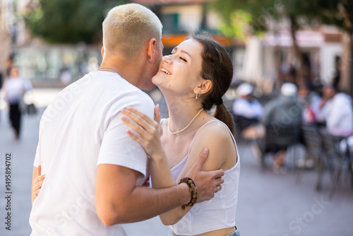Konstfotografi Guy met young female friend during walk, greets his classmate and hugs her