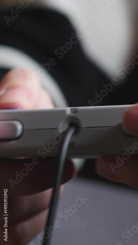 Close-Up Of A Young Woman's Hands Holding A Grey Retro Video Game Controller. Gaming, Entertainment, Technology. Vertical