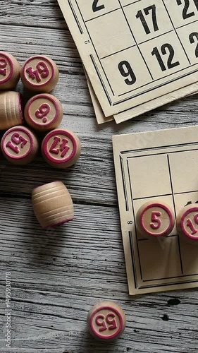 Sliding Shot Over Traditional Russian Lotto Game Pieces: Wooden Barrels With Numbers And Cards On A Wooden Table. Board Game. Vertical