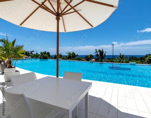 Luxury lifestyle, vibrant pool merging with the ocean horizon under a clear blue sky. Represents relaxation, vacation dreams, and highend living. Ideal for travel, real estate.