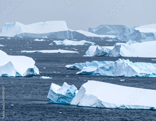 Dramatic scenery of icebergs adrift in the Antarctic ocean. Evokes themes of climate change, exploration, and natural beauty. Ideal for environmental reports, travel brochures.