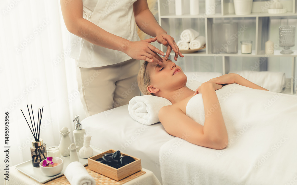 Obraz premium Caucasian woman enjoying relaxing anti-stress head massage and pampering facial beauty skin recreation leisure in dayspa modern light ambient at luxury resort or hotel spa salon. Quiescent