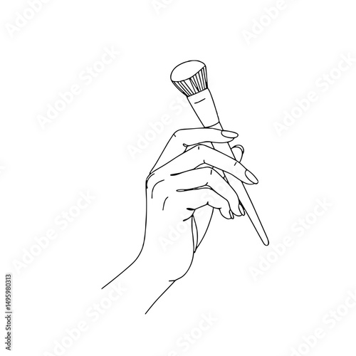 Hand holding a makeup brush with copy space