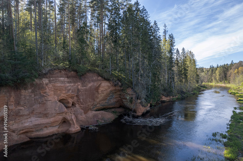 Red cliffs on Salaca river in Latvia at summer.  Cliffs in a Skanaiskalns Nature Park on Salaca river in Mazsalaca, Latvia