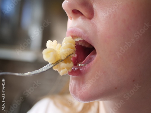 Wallpaper Mural Closse up of girl mouth eating food Torontodigital.ca