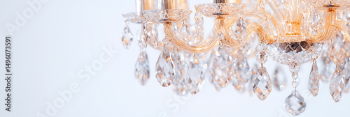 A gleaming, decorative chandelier, cascading with sparkling crystal pendants, catching the light. Adds elegance and refinement to any room.