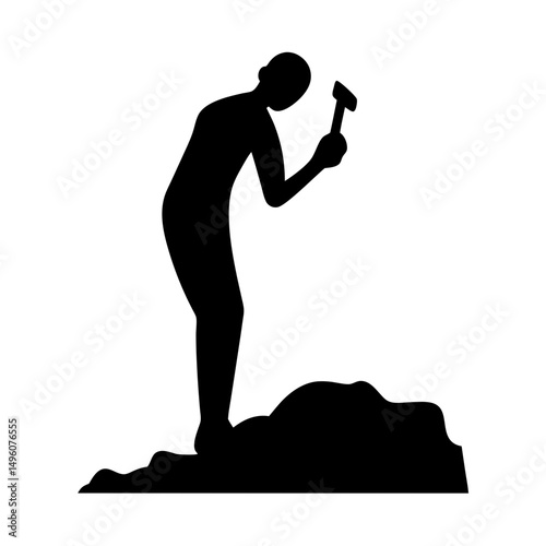 Silhouette of a figure chipping away at a mound with a hammer