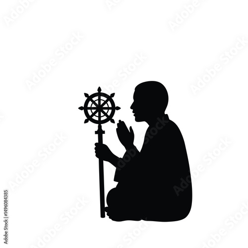 Praying monk silhouette holding dharmachakra staff