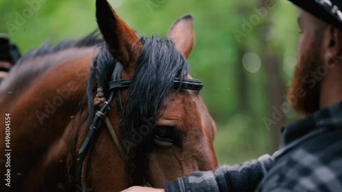 cowboy in hat with beard with horse in nature