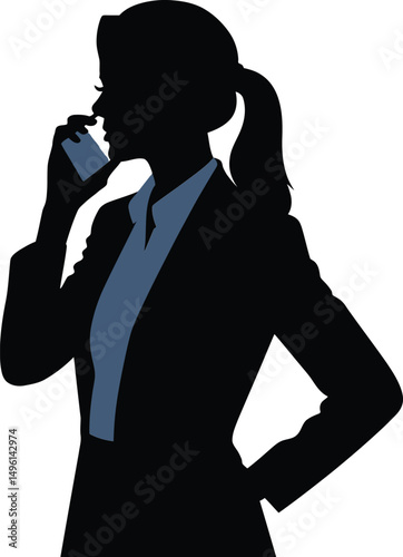 Silhouette of a businesswoman in professional attire talking on a smartphone in profile view