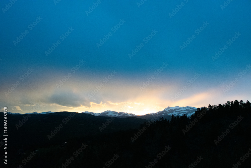 Obraz premium sun dipping behind the Colorado Rocky Mountains 