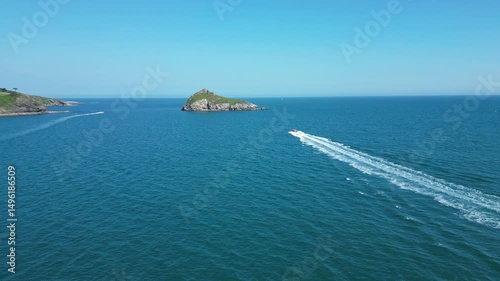 Torbay, South Devon, England: DRONE VIEWS: A speedboat heads across the bay in the direction of Thatcher Rock. Torbay is a popular UK holiday destination (Clip 1).