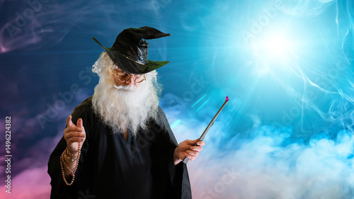 Quadro su tela Wizard old man casting spell with magic wand