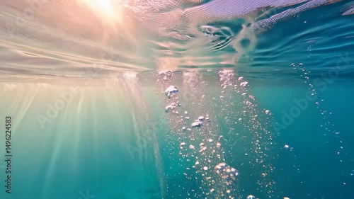 Wallpaper Mural Sunlight beams through the ocean surface creating underwater bubbles, showing the beauty and clarity of the sea on a bright day. Torontodigital.ca