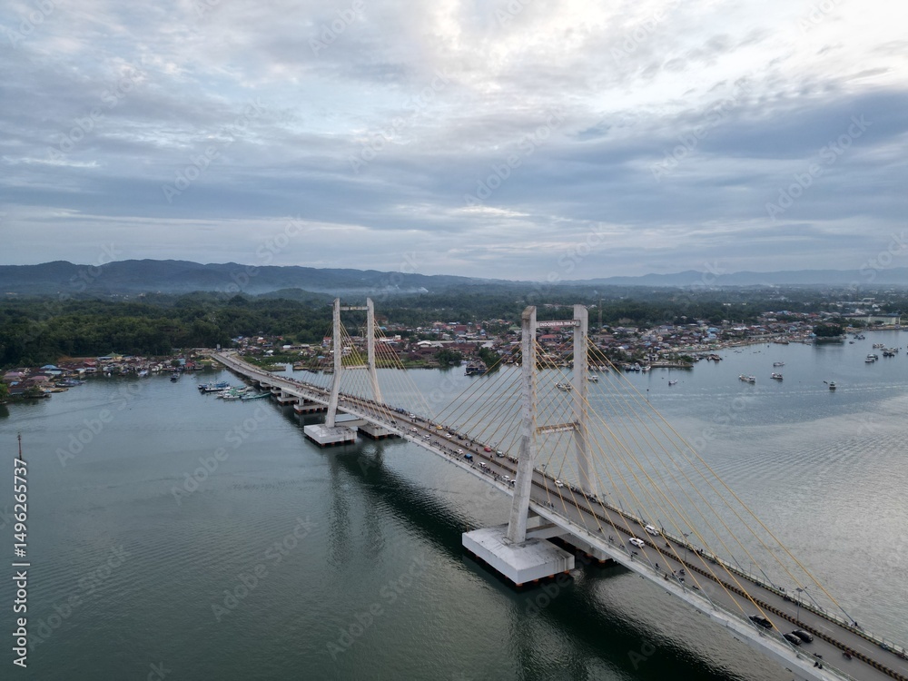 Fototapeta premium Aerial view of Kendari Bay Bridge, a suspension bridge connecting both sides of Kendari Bay in Southeast Sulawesi, Indonesia
