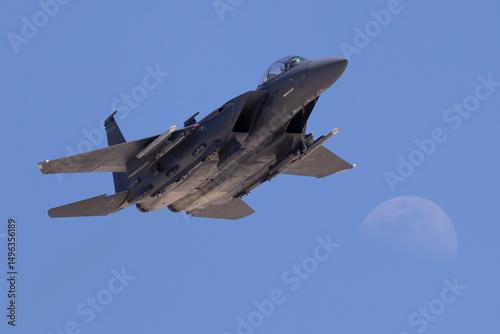 F-15 Eagle approaching n beautiful light with the moon in the background