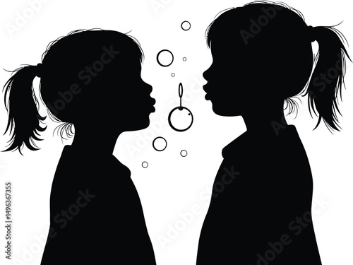 Silhouette of Two Girls Blowing Bubbles