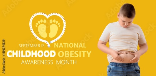 Overweight boy on yellow ba...