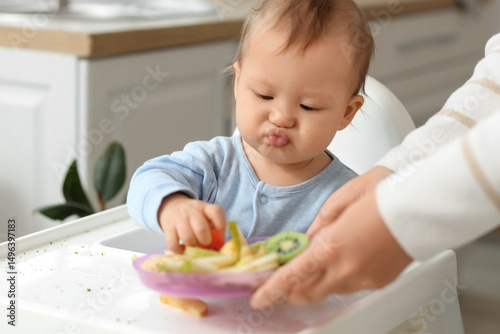 Mother feeding her little b...