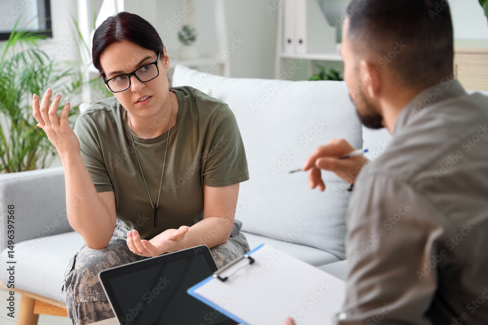 Fototapeta premium Female soldier with PTSD talking to psychologist in office