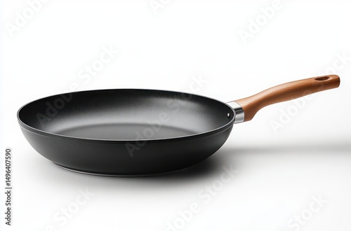 Black frying pan with non-stick surface and wooden handle placed on white background