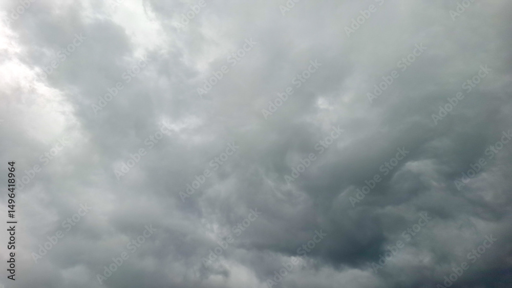 Fototapeta premium The ominous sky is filled with dense, swirling storm clouds, indicating an approaching thunderstorm.