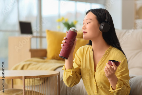 Young Asian woman drinking ...
