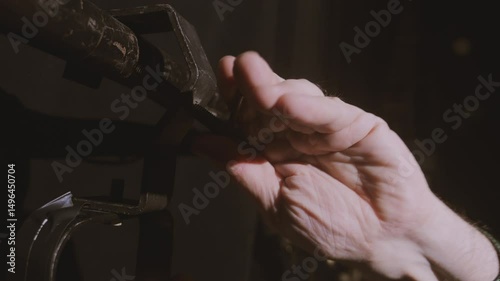 The hand of the lighting worker removes the profile spotlight from the instrument stand