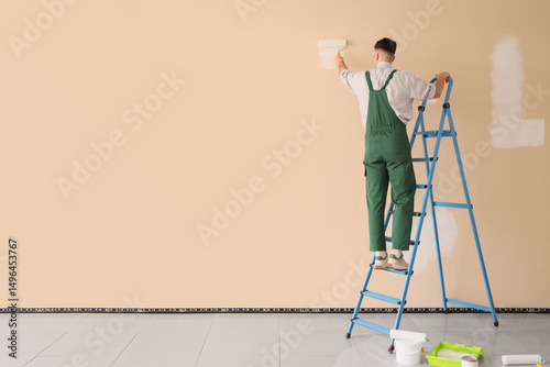 Male decorator with roller ...