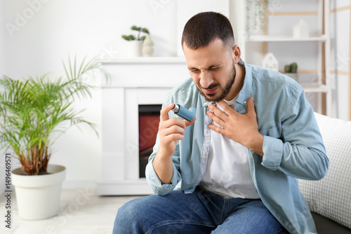 Young man with inhaler havi...