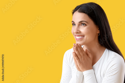 Thankful young woman on yel...