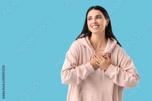 Thankful young woman on blu...