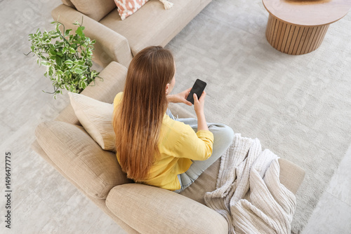 Young woman using mobile ph...