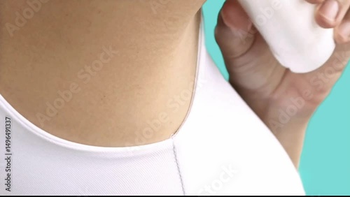 a woman who applies deodorant to her armpits