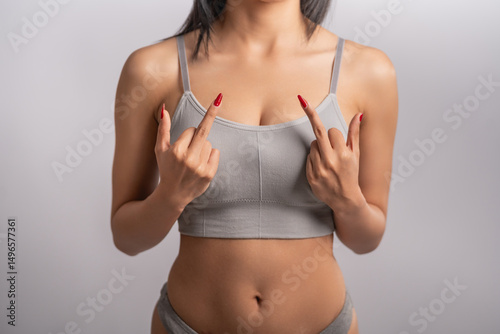 Fotografie Sexy naked woman showing fuck off with the middle finger