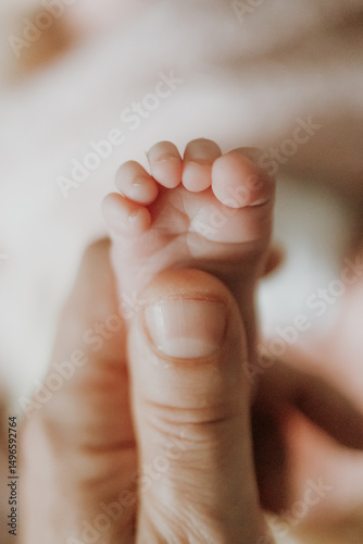 newborn baby feet in parent's hands