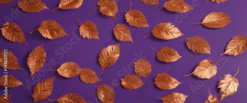 Intricate dry orange metallic leaves scattered on a rich violet background , element, dark, photography