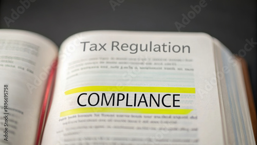 Tax Deal Compliance concept. Open book highlighting tax compliance regulations.