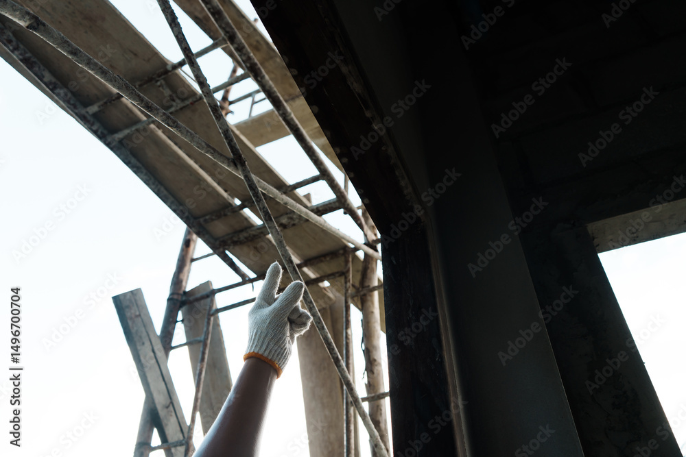 Obraz premium Construction worker inspecting framework urban site action shot daylight close up safety and precision in building