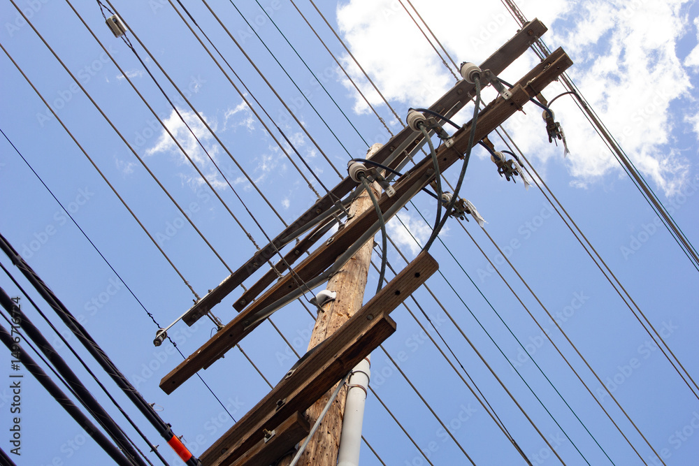 Obraz premium A view of a utility pole and power lines.