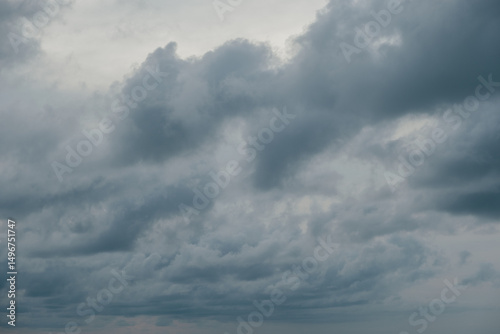Overcast sky with thick gray clouds during late afternoon, creating a moody and dramatic atmosphere. Perfect for weather themes, storm backgrounds, or environmental and nature concepts.